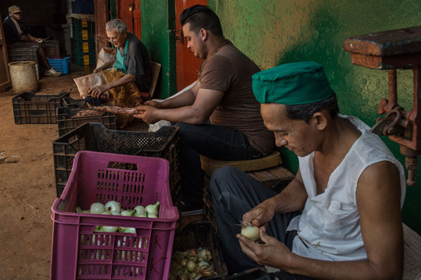 Trabajadores limpian algunos  vegetales en un mercado de frutas ubicado en la Ha